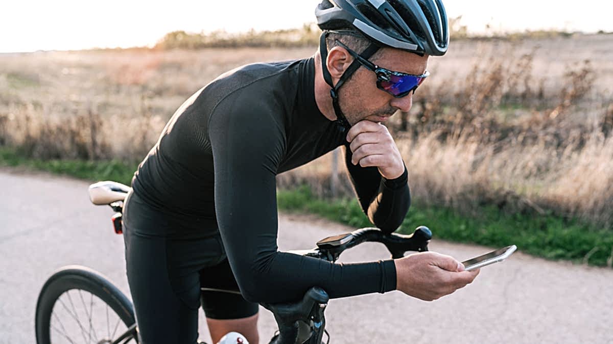 Image Of A Male Cyclist Taking A Break From His Ride To Look At Andy Coggan's Cycling Power Zones In Trainingpeaks