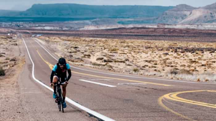 Image Of A Cyclist Riding On Desert Road To Increase Cycling Power