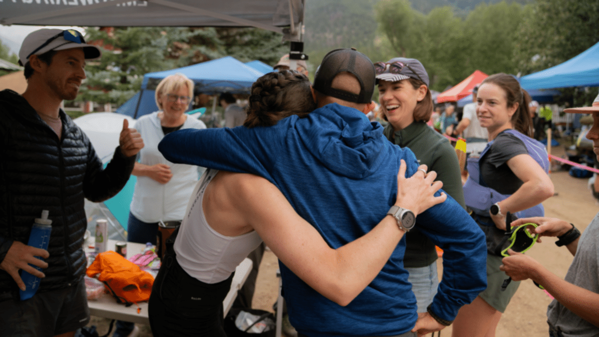 Why You Need A Coach Coach And Athlete Hugging After Endurance Event